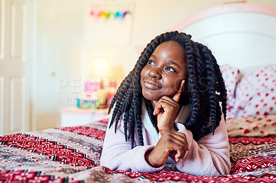 Buy stock photo Shot of an adorable little girl chilling on her bed in her bedroom