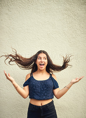 Buy stock photo Portrait of a happy teenage girl posing against a wall outside