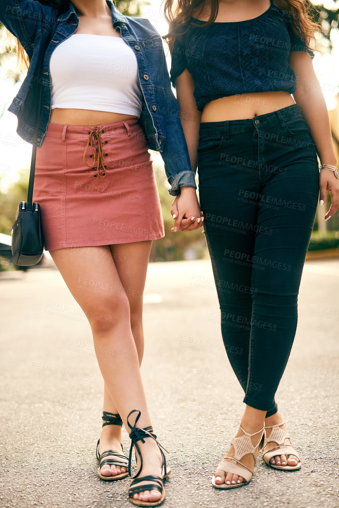 Buy stock photo Cropped shot of two unrecognizable female best friends holding hands and spending the day in the city