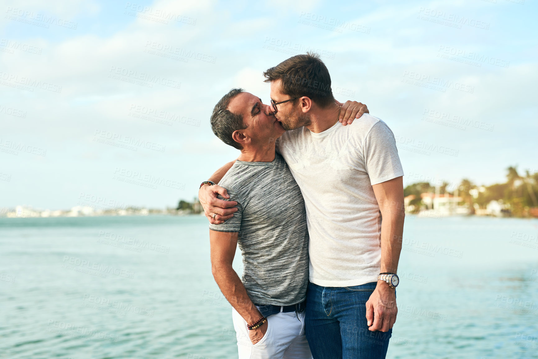 Buy stock photo Cropped shot of an affectionate mature couple spending the day by the beach