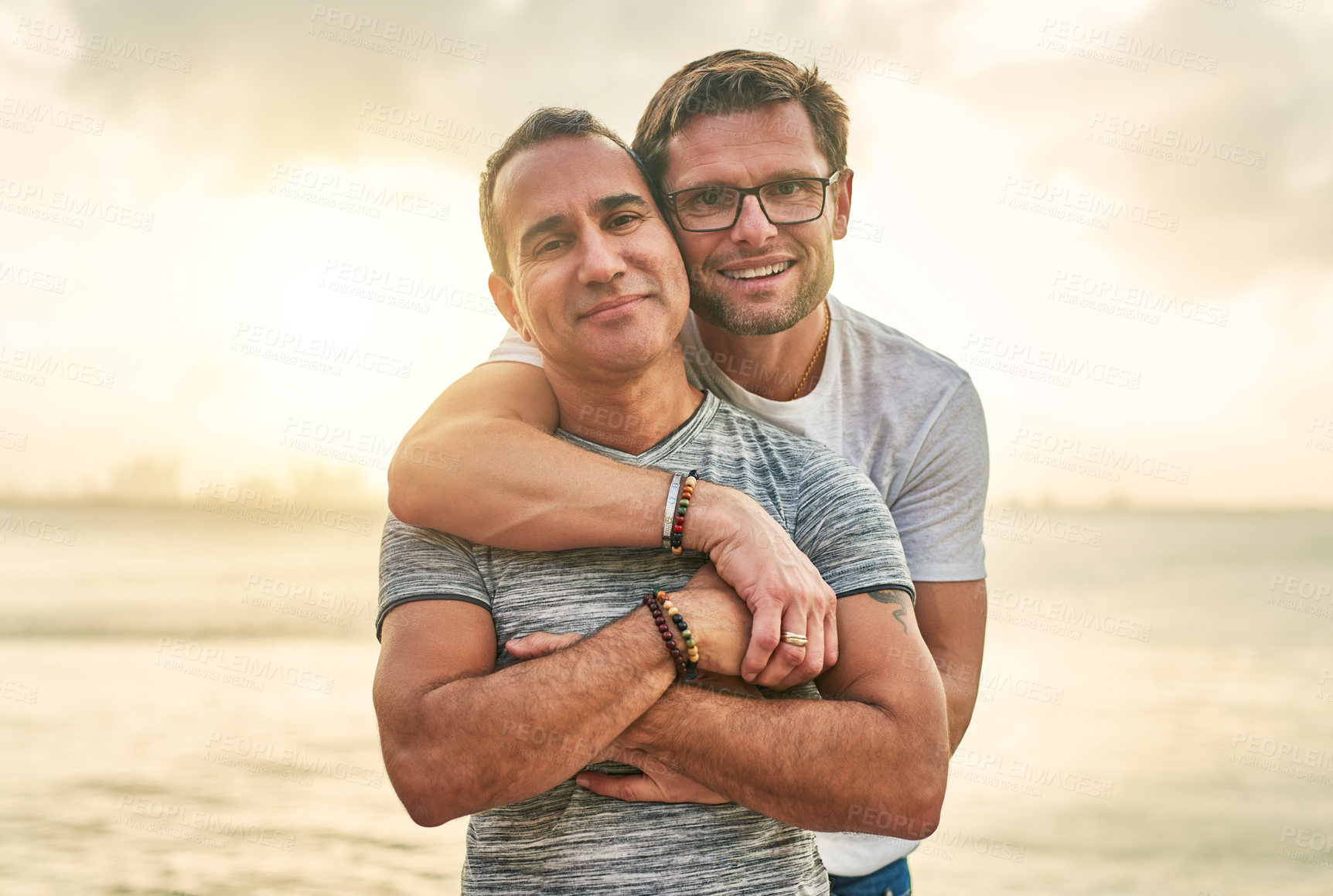 Buy stock photo Portrait of an affectionate mature couple spending the day by the beach