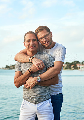 Buy stock photo Portrait, sea and hug with gay couple, love and bonding together with romance, beach and Bali. Queer people, face and men with embrace, travel and ocean with adventure, relationship and marriage