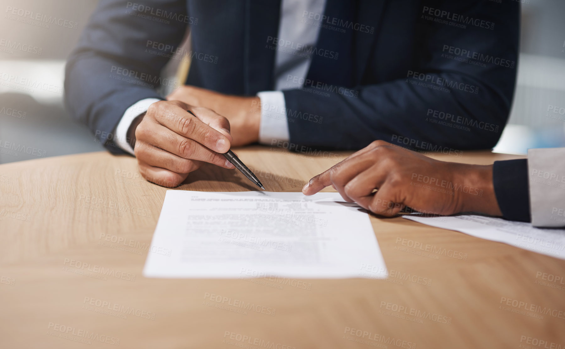 Buy stock photo Closeup shot of two unrecognizable businesspeople going through paperwork in an office