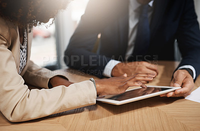 Buy stock photo Closeup shot of two unrecognizable businesspeople using a digital tablet in an office