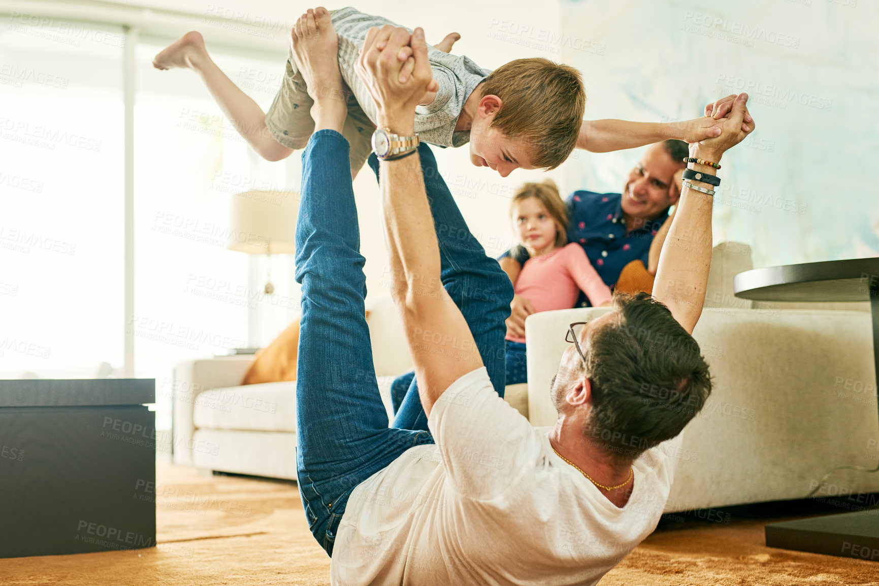 Buy stock photo Cropped shot of an adorable little boy playing with his father at home