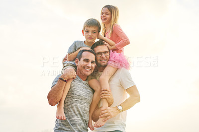 Buy stock photo Low angle portrait of an affectionate mature couple carrying their kids on their shoulders outside
