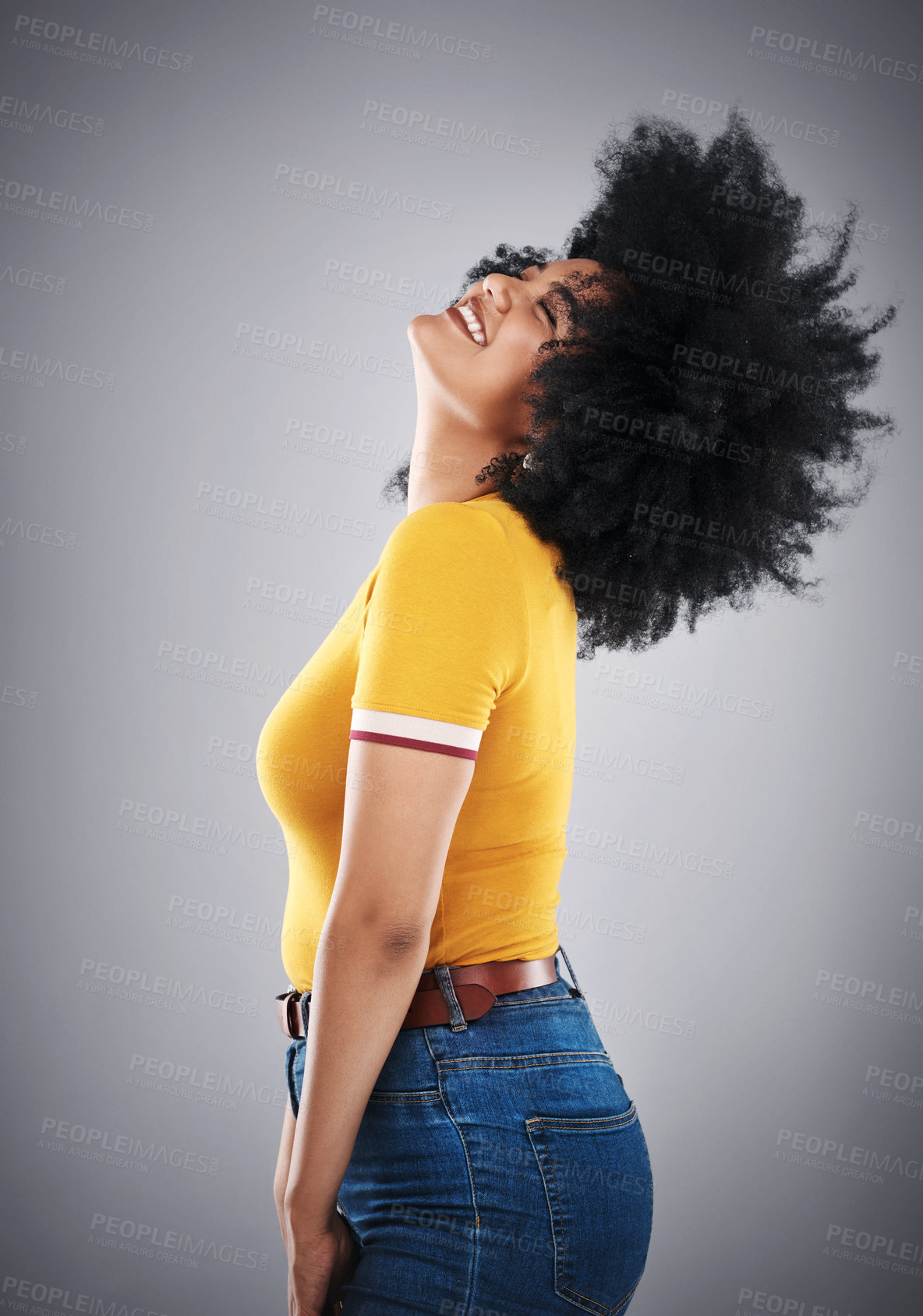 Buy stock photo African woman, hair flip and side view for trendy fashion, style or comfort for vibrant, playful or aesthetic. Fashionista, happy and cheerful in studio with jean and bold bright cotton tshirt  