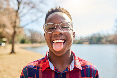 Buy stock photo Portrait of a confident young boy sticking out his tongue
