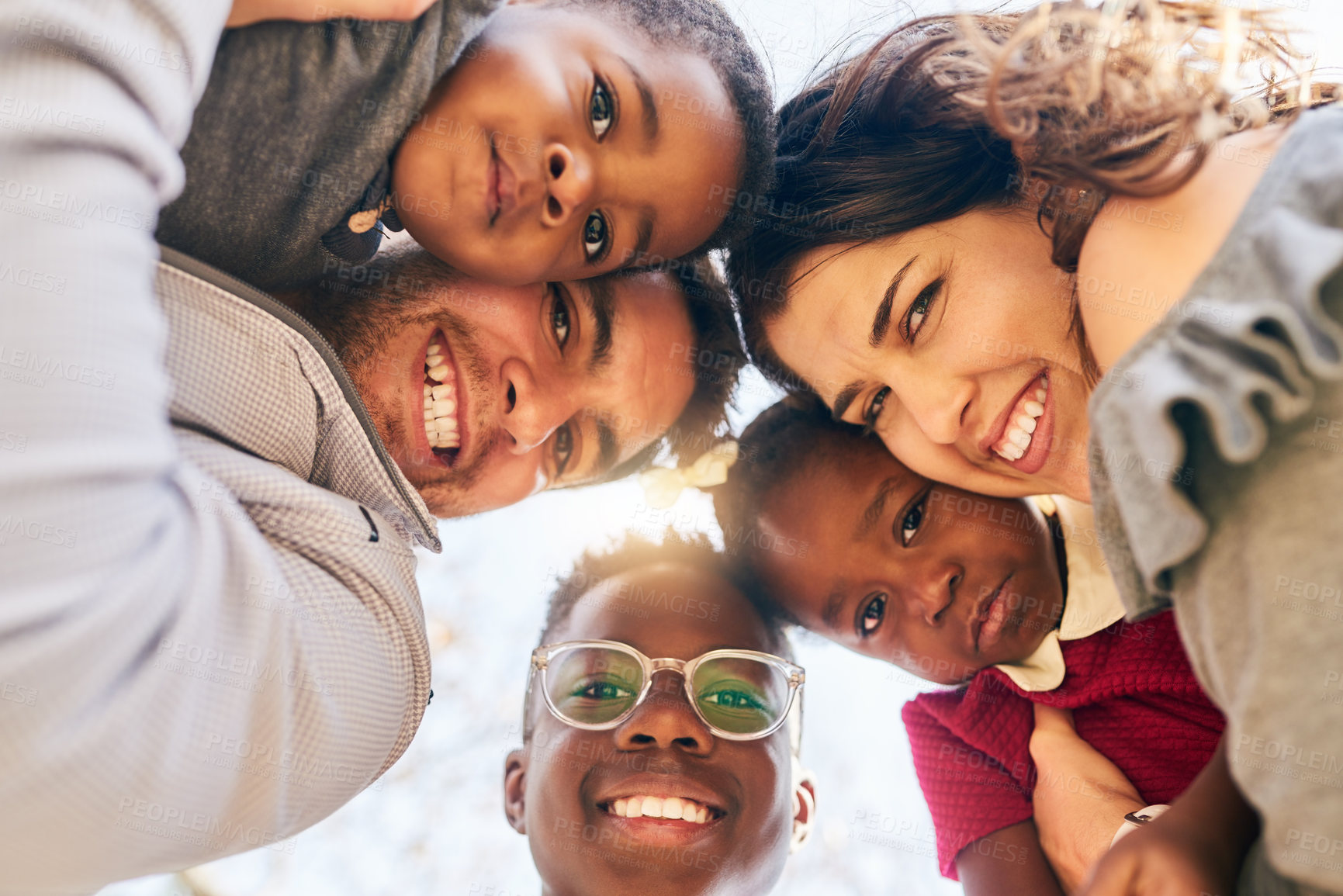 Buy stock photo Portrait of a happy family bonding together outdoors