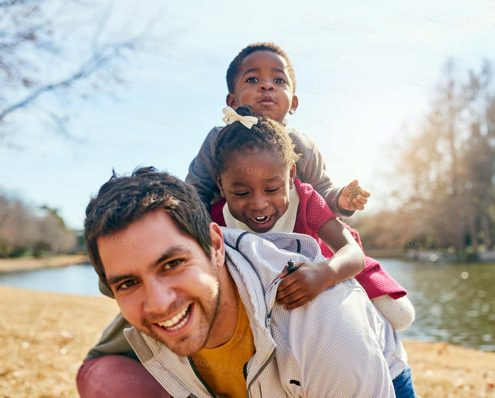 Buy stock photo Father, children and adoption with piggyback, smile and field for fun and playing in park. Vacation, interracial family and kids with bonding, carry and joy together for summer holiday confidence