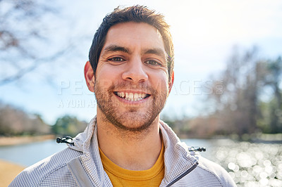 Buy stock photo Portrait of a handsome young man spending some time outdoors