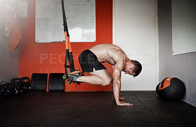Buy stock photo Full length shot of a handsome and muscular young man working out in the gym