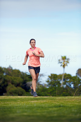 Buy stock photo Shot of a young attractive woman running outside