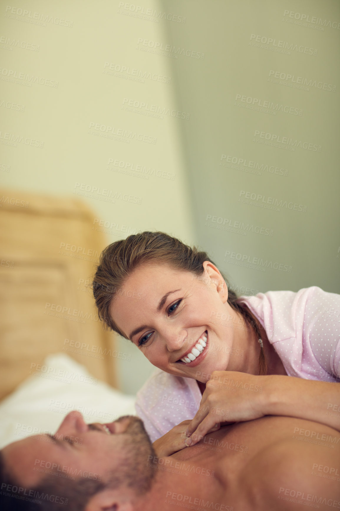 Buy stock photo Cropped shot of a young attractive wife lying on her husband's chest in bed at home