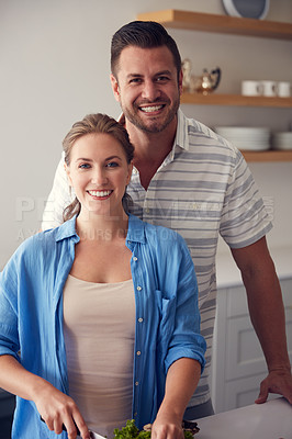 Buy stock photo Portrait of a married couple making food together in the kitchen at home