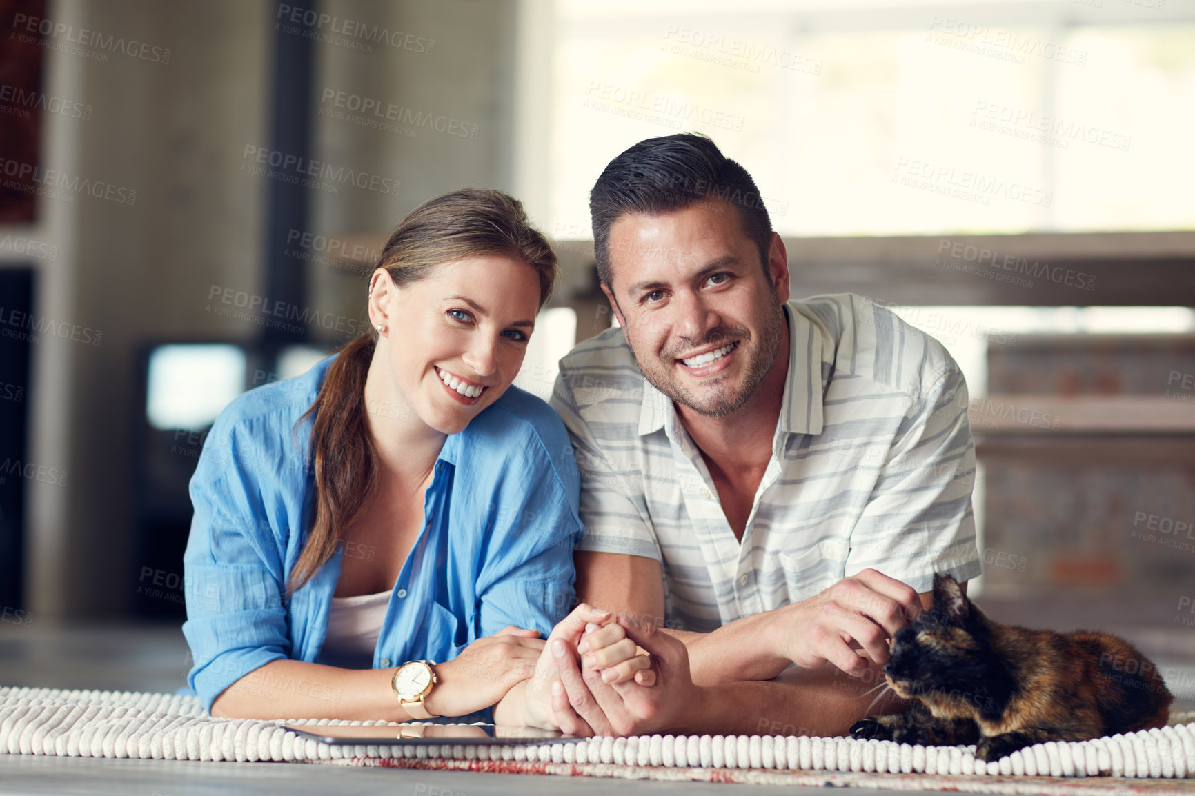 Buy stock photo Portrait of a young married couple spending the day with their pet at home