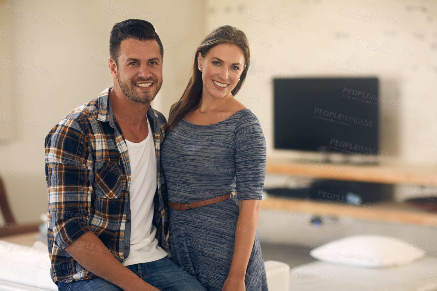 Buy stock photo Portrait of a young married couple spending the day at home