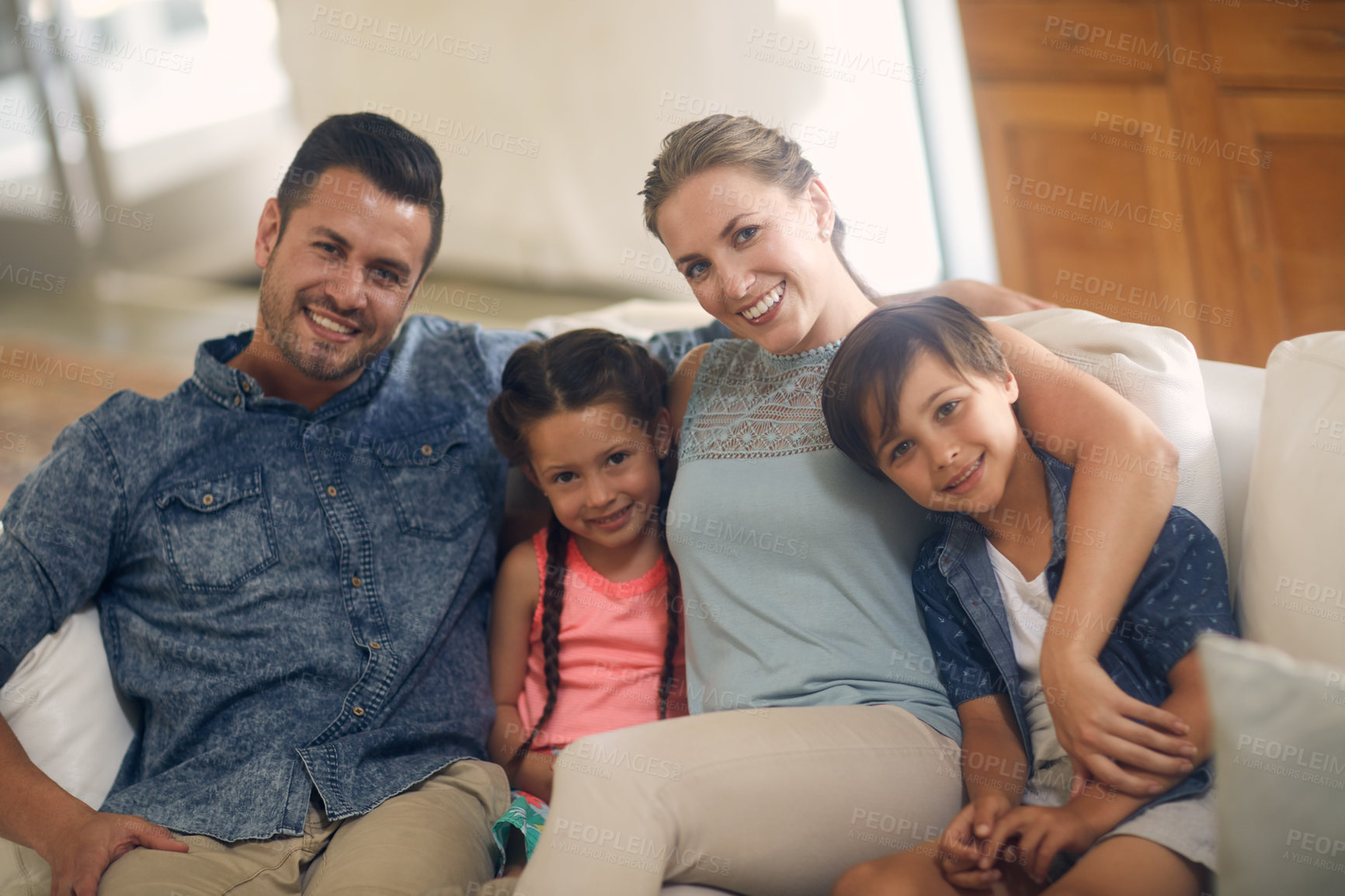 Buy stock photo Shot of a family of four spending quality time together at home