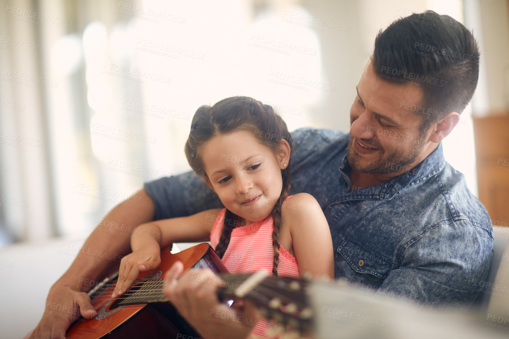 Buy stock photo Shot of a father and daughter spending time together at home