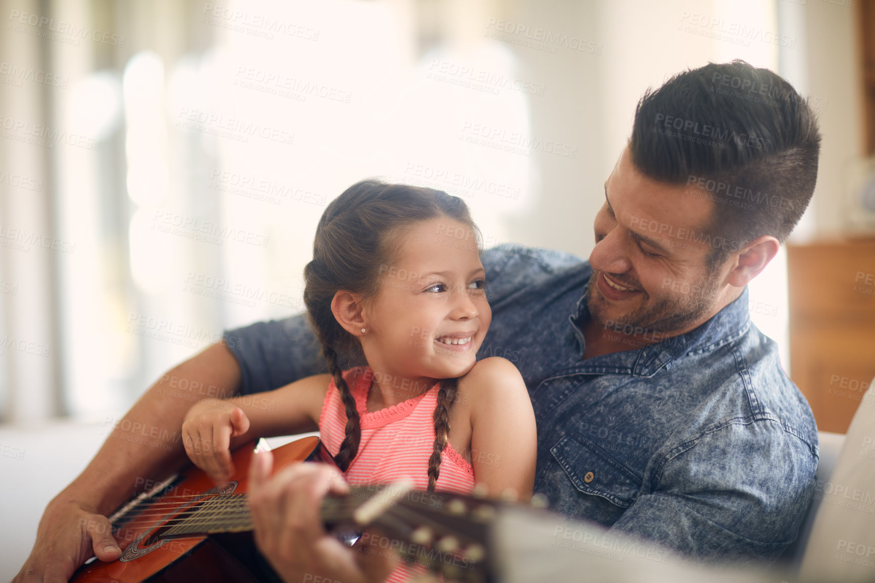 Buy stock photo Shot of a father and daughter spending time together at home
