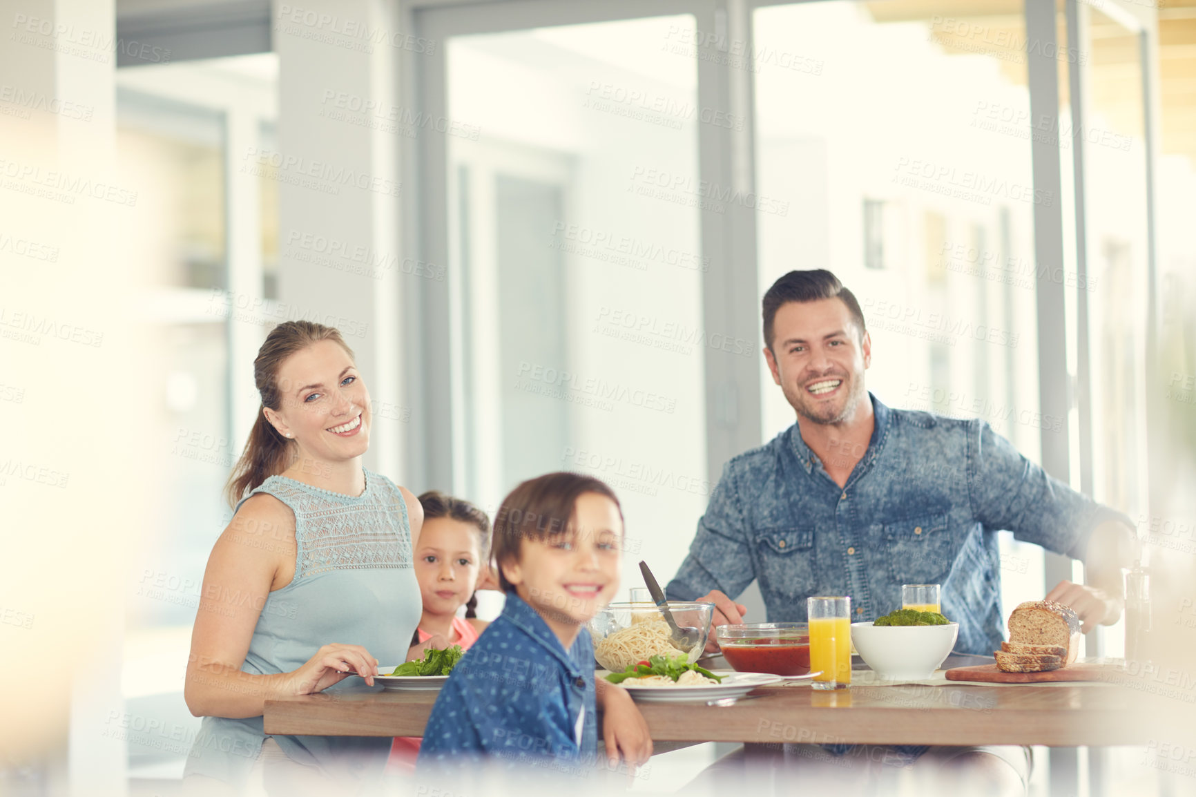 Buy stock photo Shot of a family of four having lunch at home