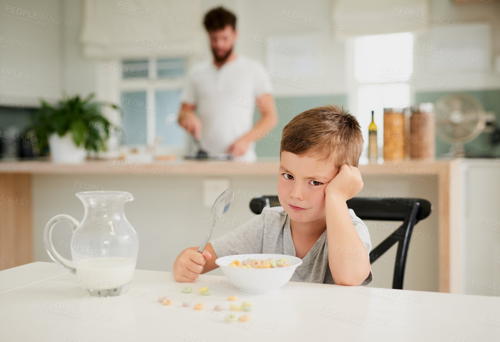 Buy stock photo Shot of a little boy refusing to eat his breakfast at home