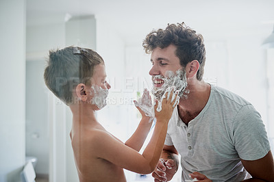 Buy stock photo Child, father and learning to shave, smile and bonding together in home bathroom. Happy, dad and teaching kid with shaving cream on face beard, playing or cleaning, hygiene or enjoying hair removal.