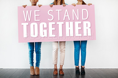 Buy stock photo Hands, sign and people for protesting in studio, women rights and solidarity or unity on backdrop. Support, women and words for awareness or freedom, message and letters for equality or together