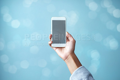 Buy stock photo Female hand, isolated, holds phone with blank screen with copy space ready for your app or online internet search Close up of a businesswoman holding a smartphone against a blurred blue background