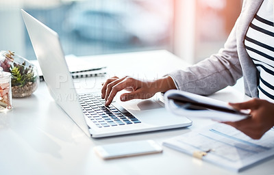 Buy stock photo Hands of a female entrepreneur sending emails and doing research on the internet. Businesswoman, secretary and data professional typing on a laptop while analyzing financial reports in her office. 