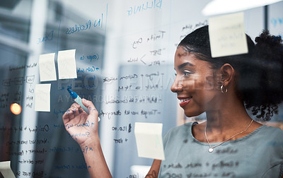 Buy stock photo Female entrepreneur planning an innovative strategy on a glass wall in a corporate office. Happy, confident and successful corporate woman brainstorming ideas for the company's progress at a company