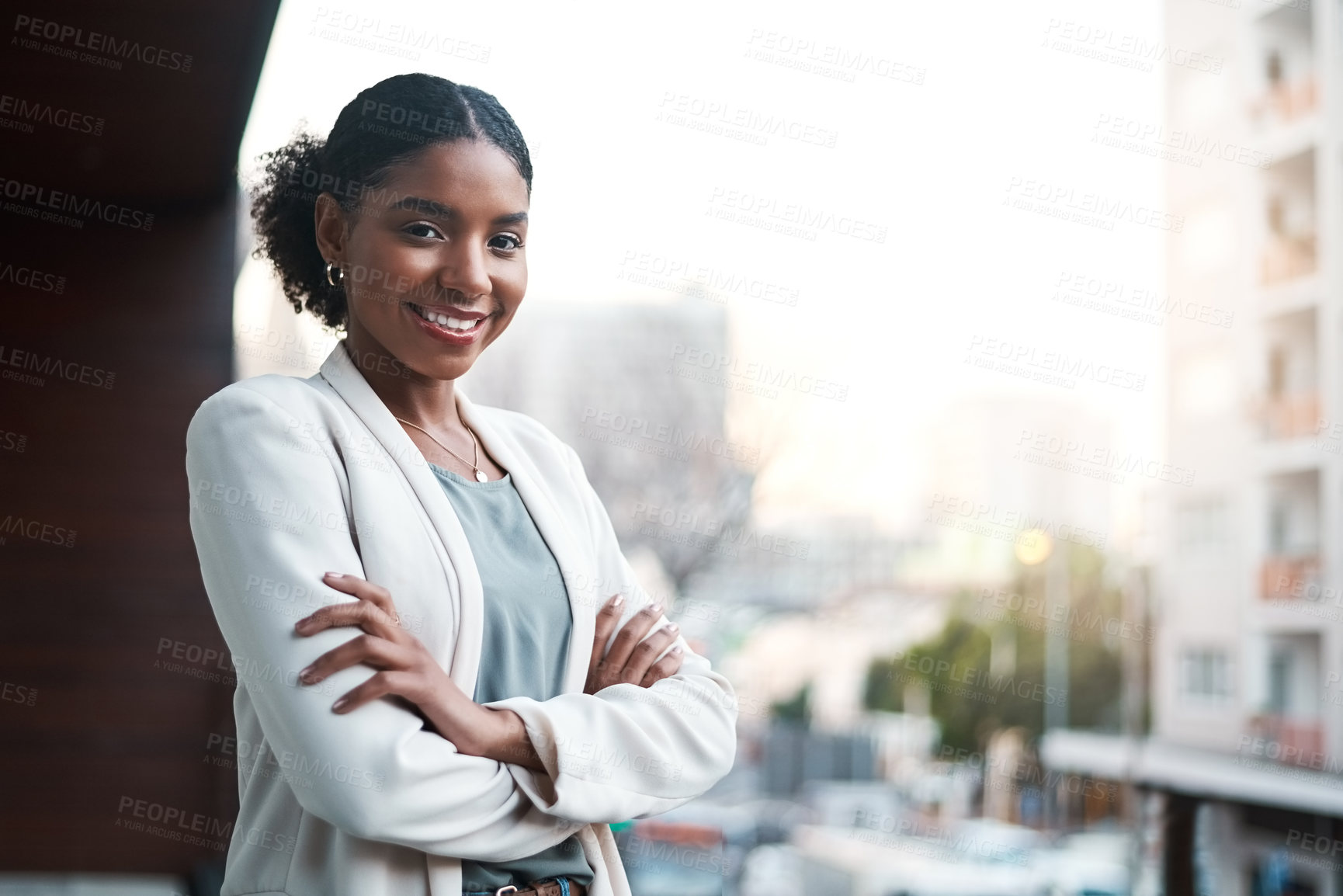 Buy stock photo Young, confident and ambitious business woman standing arms crossed on a balcony outside in the city. Portrait of a happy, smiling and positive female corporate professional ready for a new start