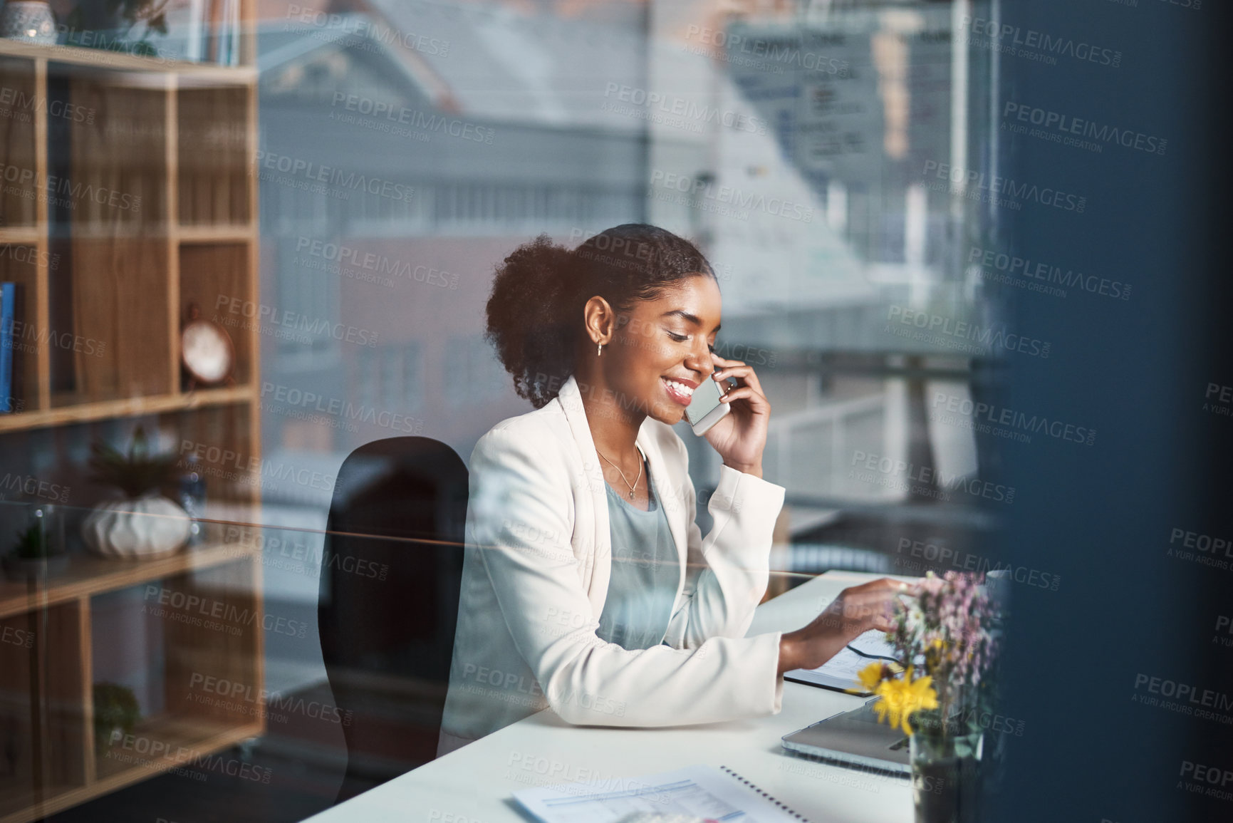 Buy stock photo Business woman talking on phone call or young entrepreneur receiving good news in work office. Happy, black female smiling and speaking to a client or listening to voice message on social media.