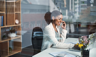 Buy stock photo Business woman on a phone call sitting at a desk typing an email on a office computer. Smiling corporate female talking about work while working online. A modern worker with a smile using technology