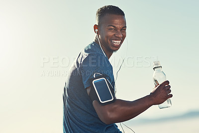 Buy stock photo Black man, drink water and portrait in outdoors for running, thirst and hydrate on sports break. Person, blue sky and mineral liquid in bottle for nutrition, music and phone app for streaming song