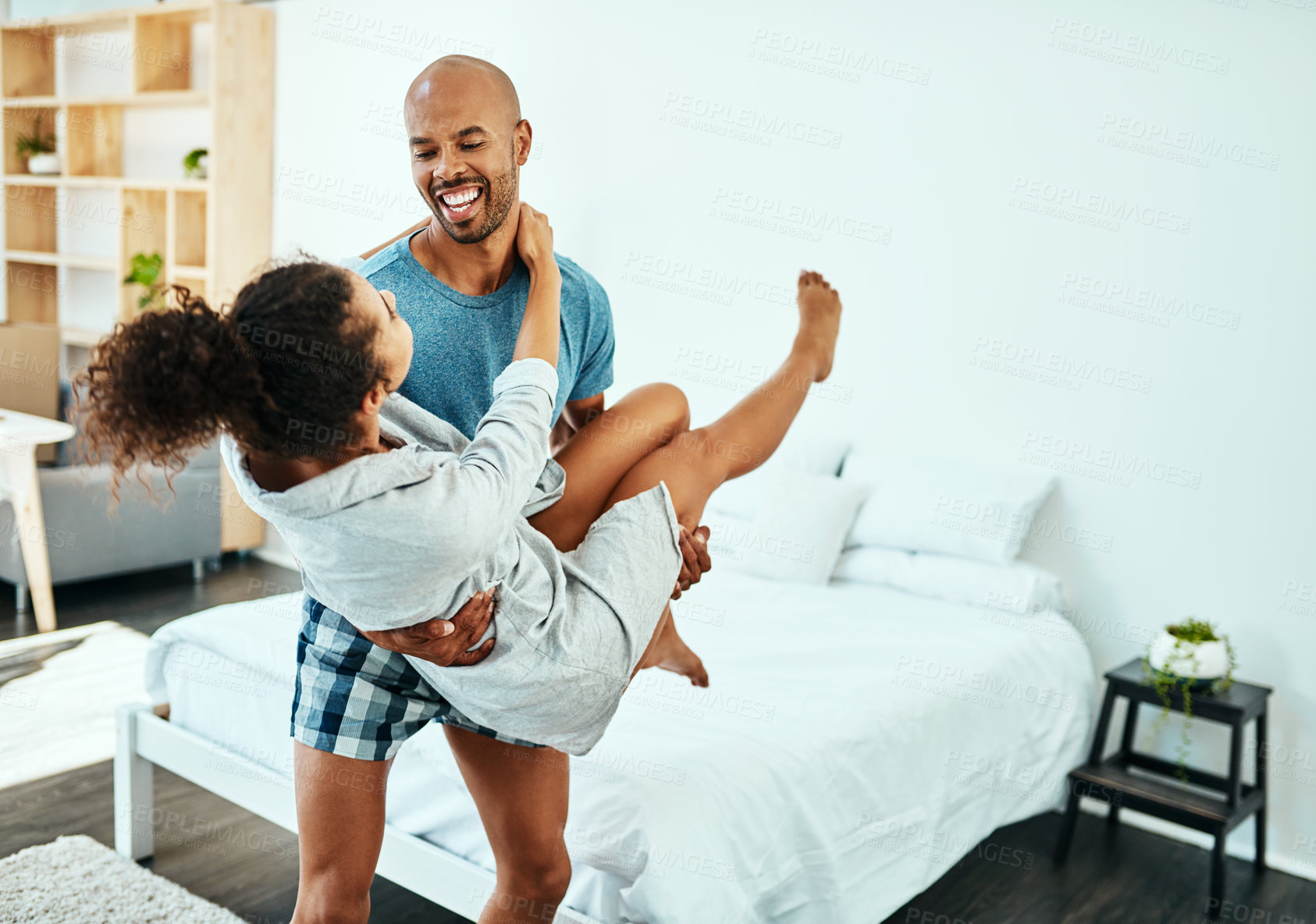 Buy stock photo Man, carry and woman in bedroom, smile and hug with care, trust and bonding with love in home. Couple, excited and happy with games, playful and connection with laughing in morning at apartment