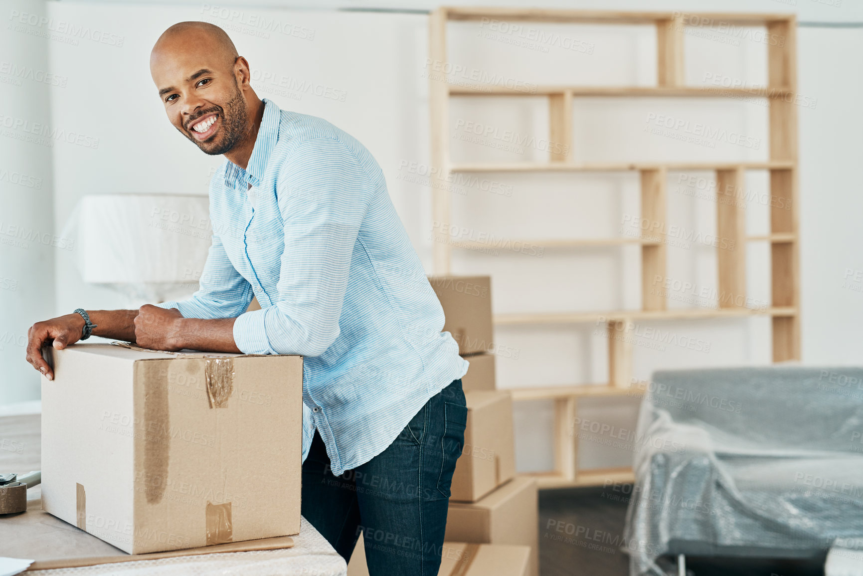 Buy stock photo Portrait of a young man moving house