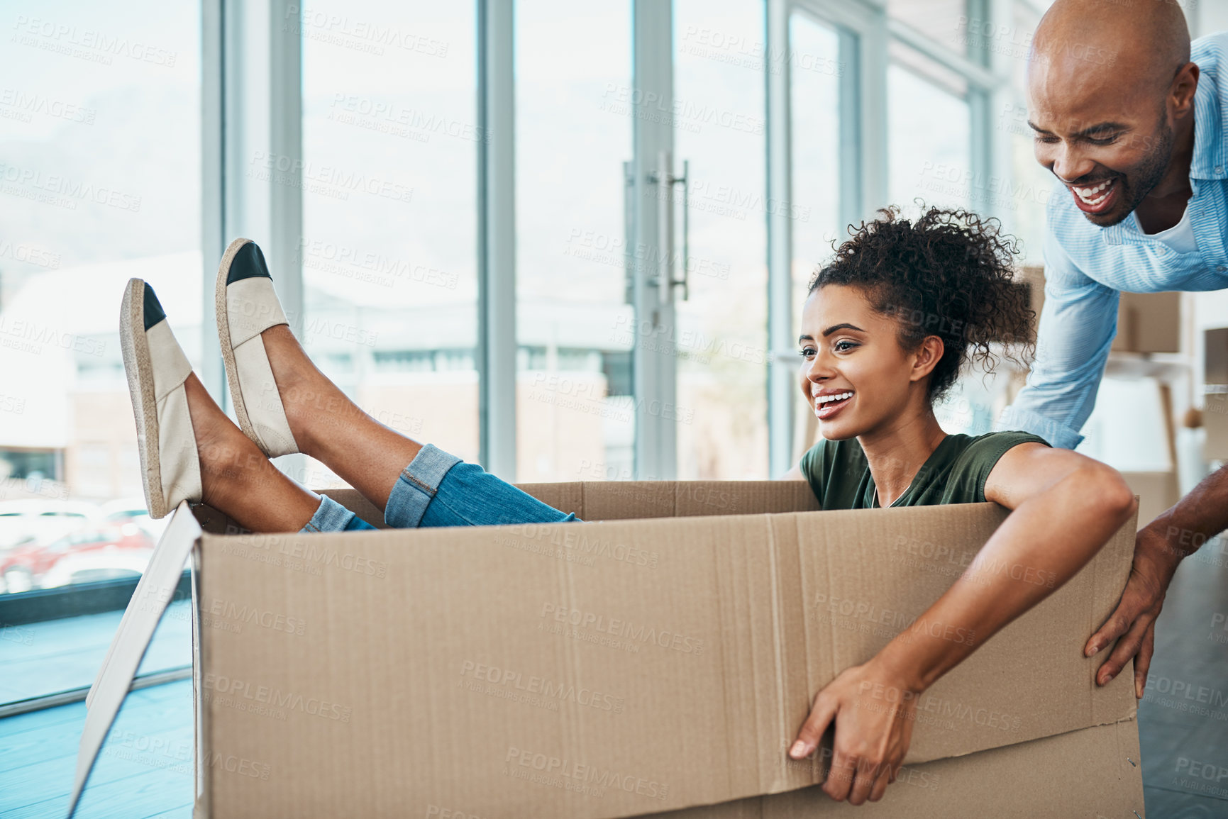Buy stock photo Shot of a young couple having fun while moving house