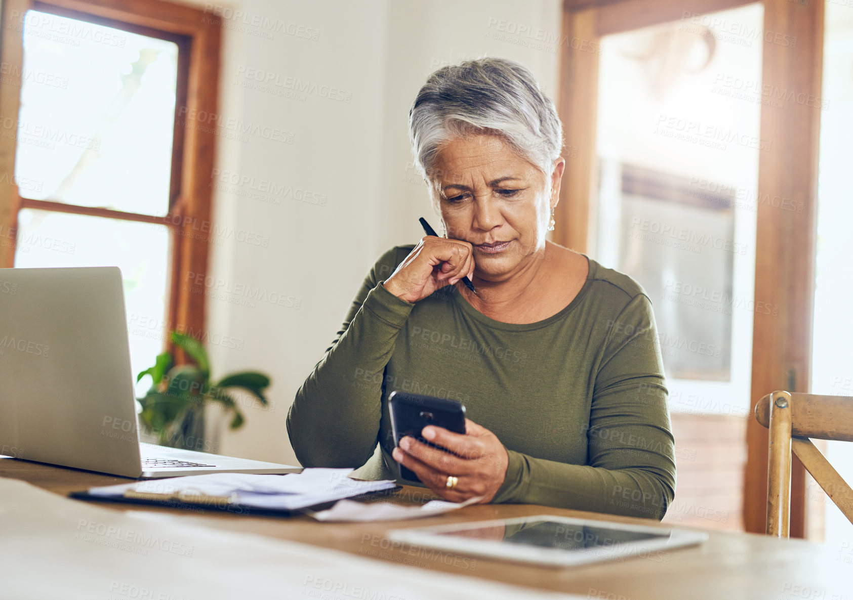 Buy stock photo Senior woman, budget planning and mobile savings checklist with phone at home. Pension, contract and elderly female person with debt, online tax and paper form in a house with bills and web admin