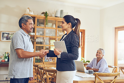 Buy stock photo Shot of a mature couple meeting with their financial consultant at home