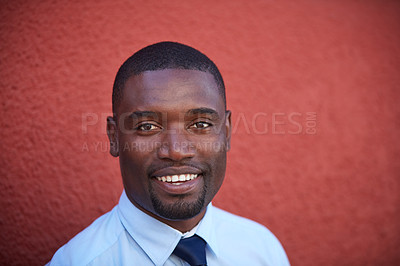 Buy stock photo Portrait of a young businessman standing against a red wall outdoors