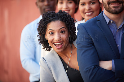 Buy stock photo Portrait of a young businesswoman standing amongst her colleagues outdoors