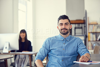 Buy stock photo Portrait of a young businessman working at her desk in a modern office
