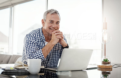 Buy stock photo Portrait of a mature man working on a laptop at home