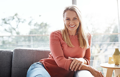 Buy stock photo Portrait of an attractive mature woman relaxing on the sofa at home