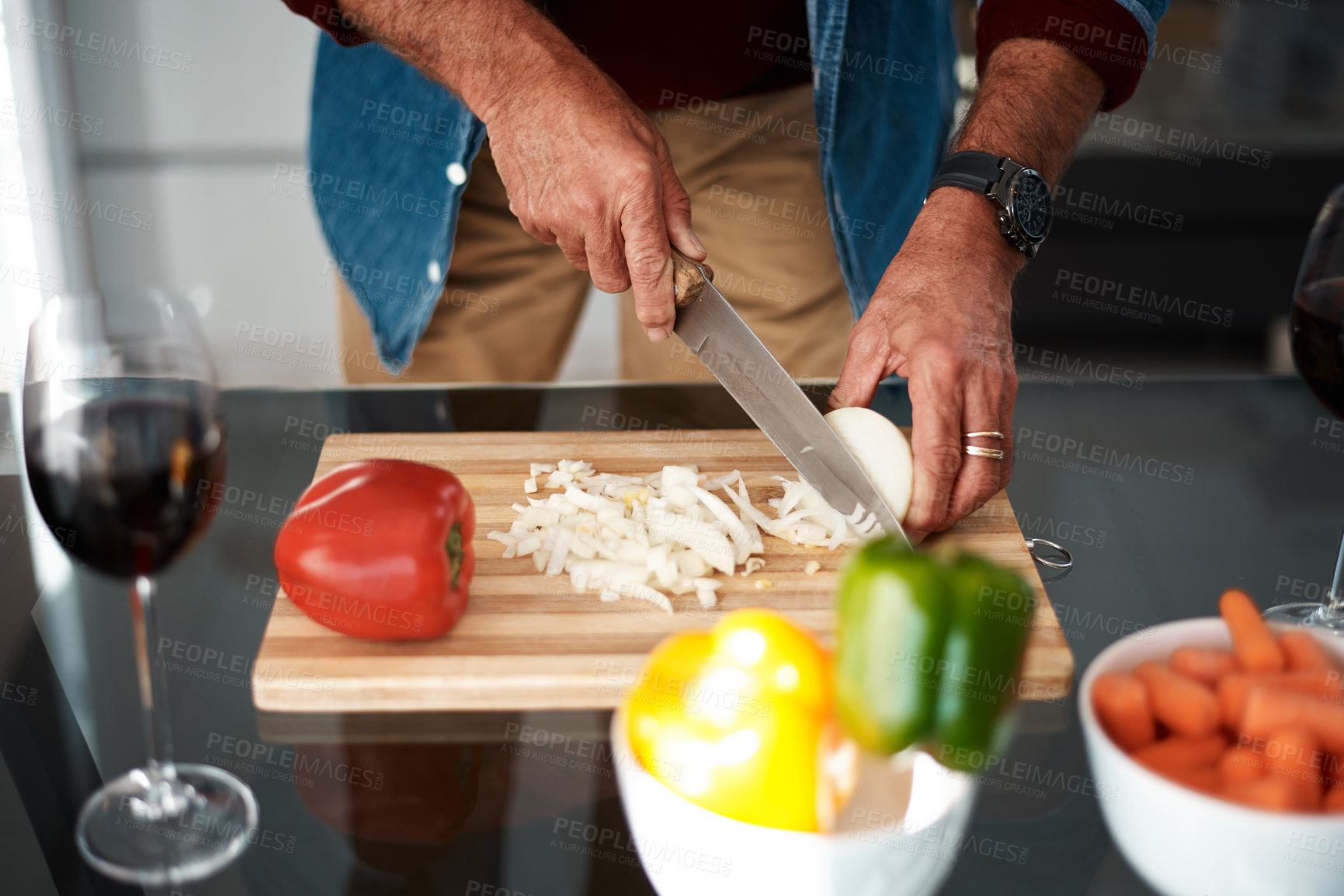 Buy stock photo Cropped shot of an unrecognizable man chopping onions on a cutting board
