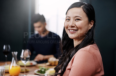 Buy stock photo Portrait of a beautiful young woman having a meal with her husband at home