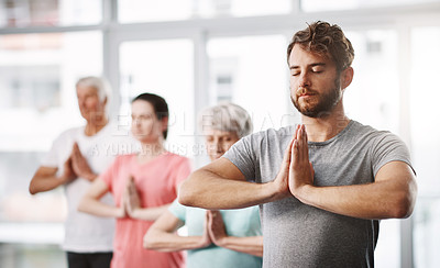 Buy stock photo Cropped shot of a group of people meditating while practicing yoga