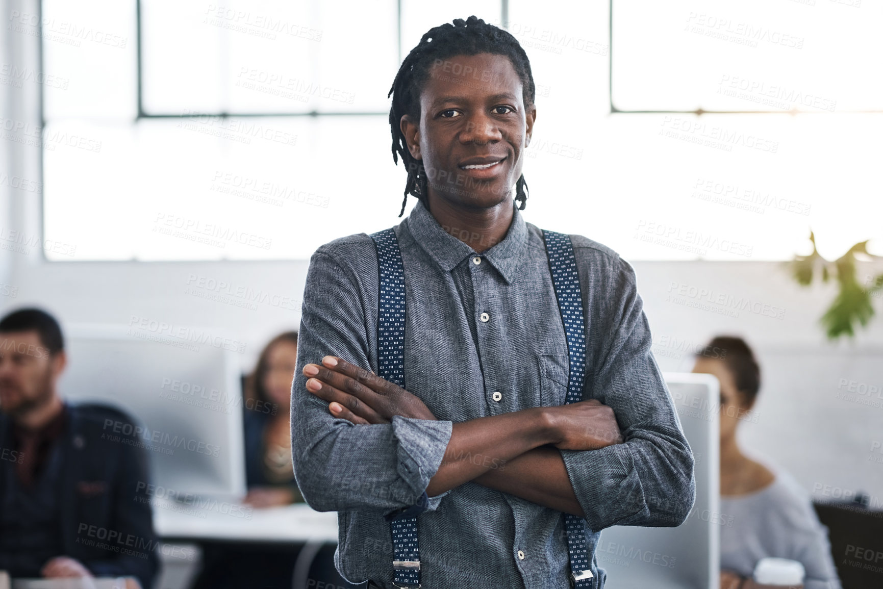 Buy stock photo Portrait of a confident young businessman working in a modern office