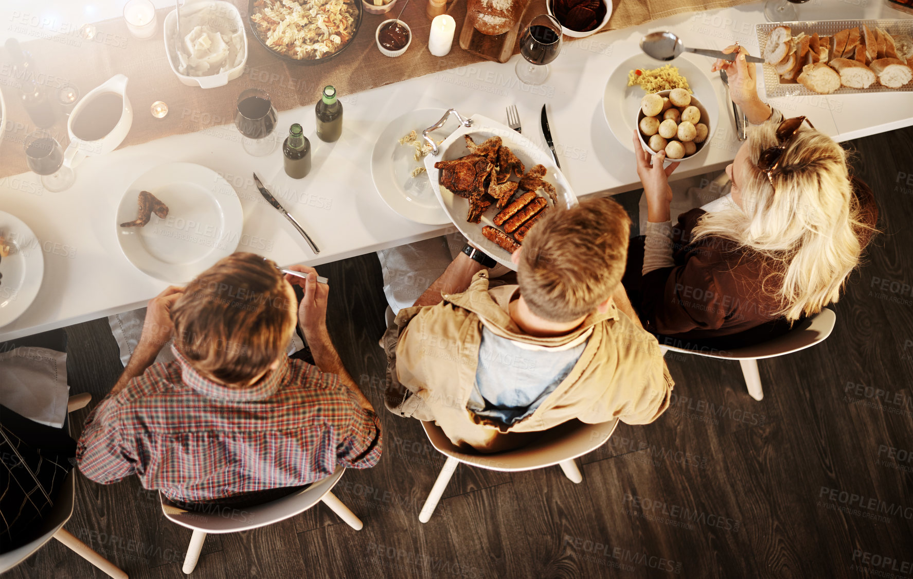 Buy stock photo High angle shot of friends getting together for a dinner party